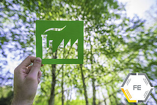 Industry symbol on green background including Fluid Engineering logo